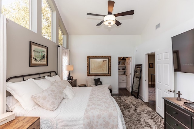 bedroom with visible vents, high vaulted ceiling, dark wood finished floors, and a ceiling fan