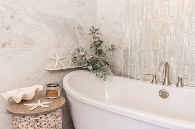 full bathroom featuring tile walls and a freestanding tub