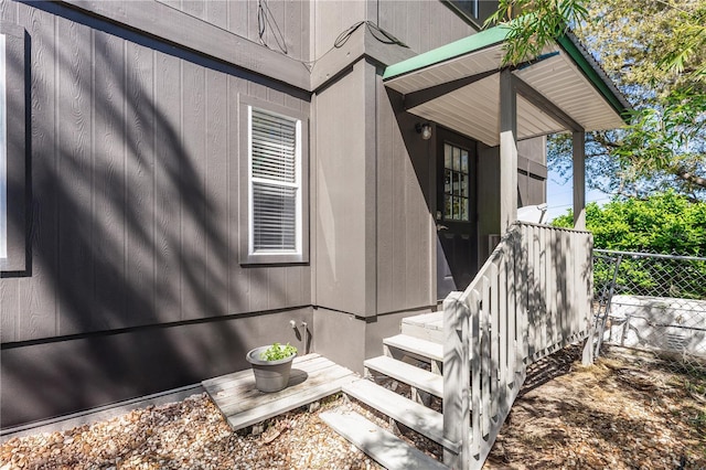 doorway to property featuring fence