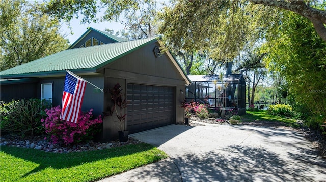 garage featuring concrete driveway