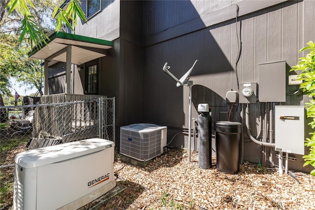 view of home's exterior featuring cooling unit and fence