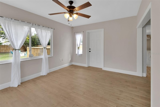 unfurnished room featuring light wood-style floors, baseboards, and ceiling fan