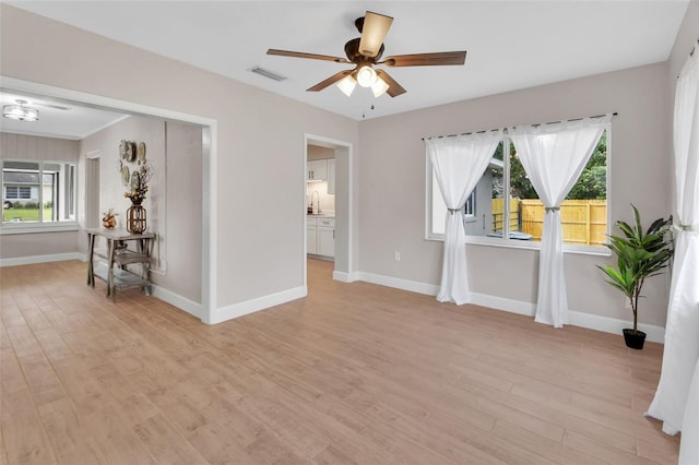 unfurnished room with plenty of natural light, light wood-style floors, and a sink