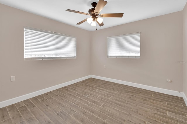 unfurnished room featuring wood finished floors, baseboards, and ceiling fan