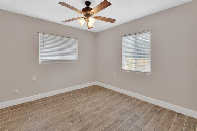 unfurnished room with baseboards, light wood-style floors, and a ceiling fan