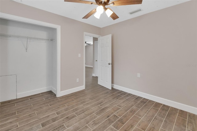 unfurnished bedroom with visible vents, wood finished floors, a closet, baseboards, and ceiling fan