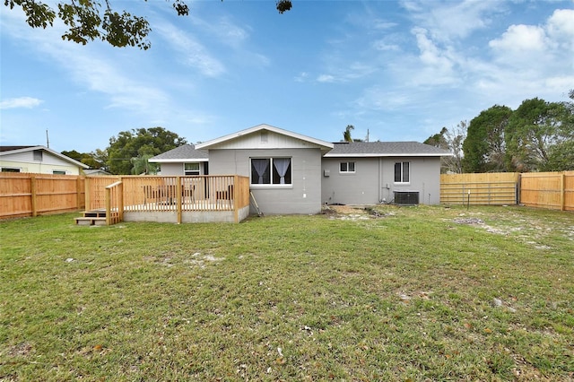 rear view of house featuring a yard, a wooden deck, central AC unit, and a fenced backyard