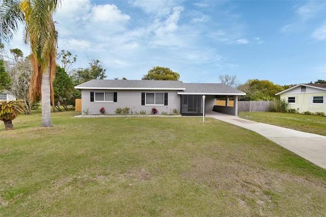 single story home featuring an attached carport, fence, driveway, stucco siding, and a front lawn