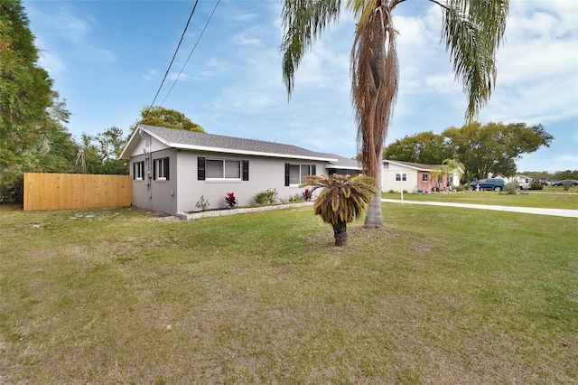 view of front facade with a front yard and fence