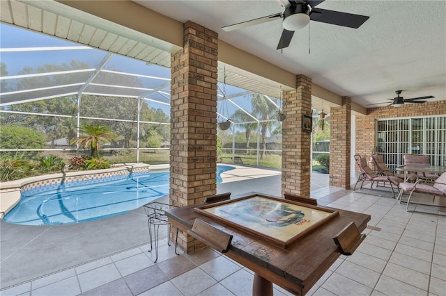 outdoor pool featuring a lanai, a ceiling fan, and a patio area