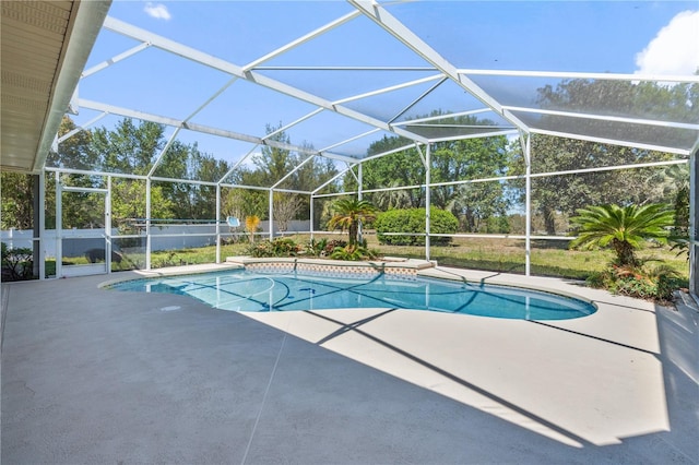 pool featuring glass enclosure and a patio