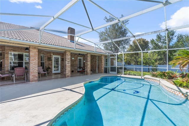 view of swimming pool featuring a fenced in pool, a patio, glass enclosure, and fence