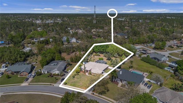 birds eye view of property with a forest view and a residential view