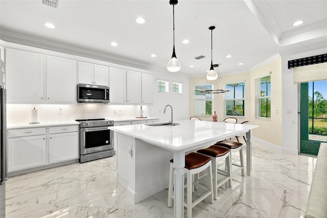 kitchen featuring ornamental molding, plenty of natural light, marble finish floor, stainless steel appliances, and a sink