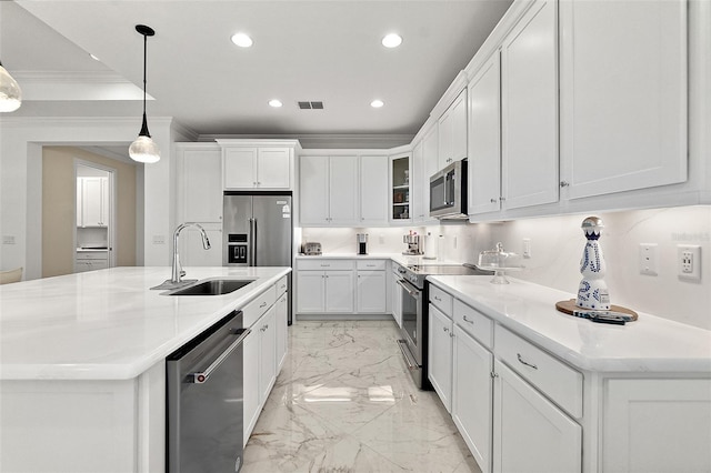 kitchen with visible vents, a sink, ornamental molding, stainless steel appliances, and marble finish floor