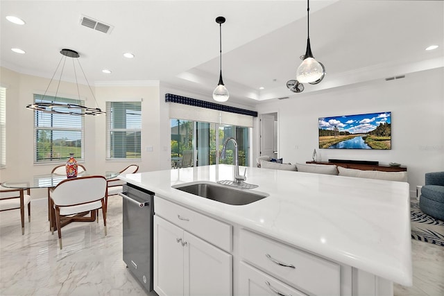 kitchen featuring visible vents, a sink, open floor plan, crown molding, and a raised ceiling