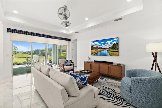 living room featuring baseboards, visible vents, a tray ceiling, ornamental molding, and marble finish floor