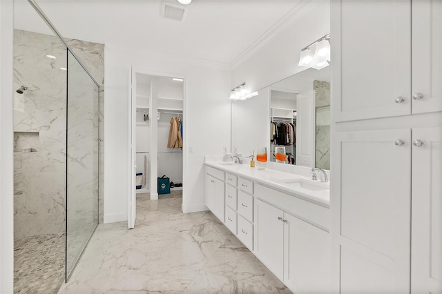 full bath with ornamental molding, marble finish floor, a marble finish shower, and a sink