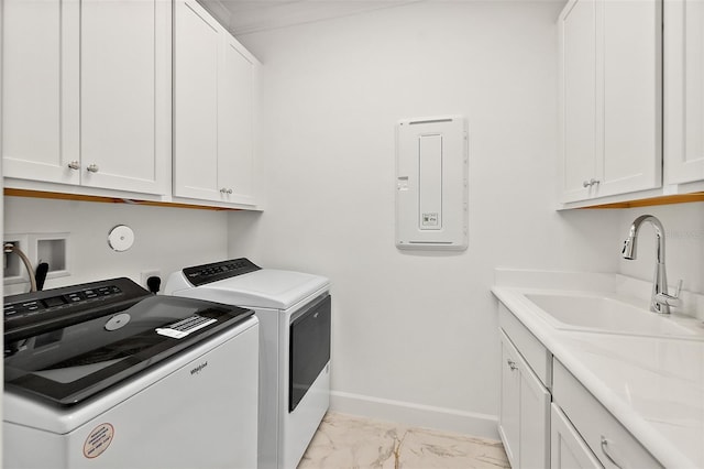 laundry area featuring baseboards, separate washer and dryer, cabinet space, a sink, and marble finish floor