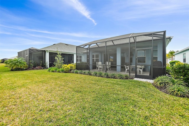 back of house with a lanai, a patio, and a yard