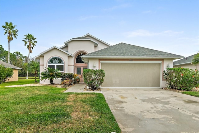 ranch-style house featuring stucco siding, a front lawn, a garage, and driveway