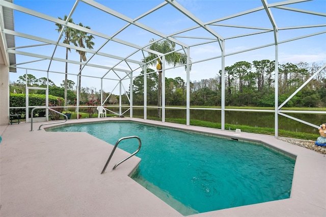 outdoor pool featuring glass enclosure and a patio