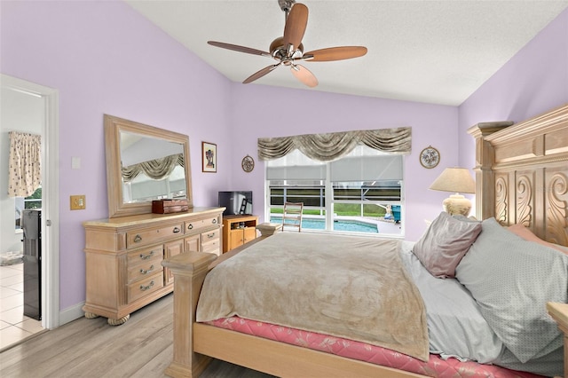 bedroom with ceiling fan, baseboards, light wood-style flooring, and vaulted ceiling