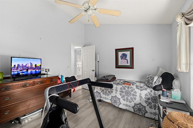 bedroom featuring ceiling fan, lofted ceiling, and wood finished floors