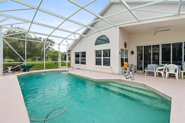 outdoor pool with a lanai, a ceiling fan, and a patio area