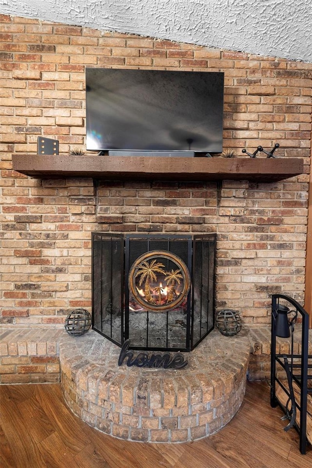 room details featuring a fireplace and wood finished floors