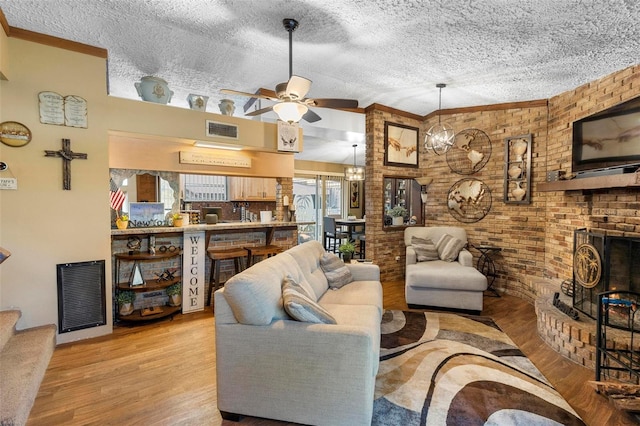 living area with wood finished floors, visible vents, and ceiling fan