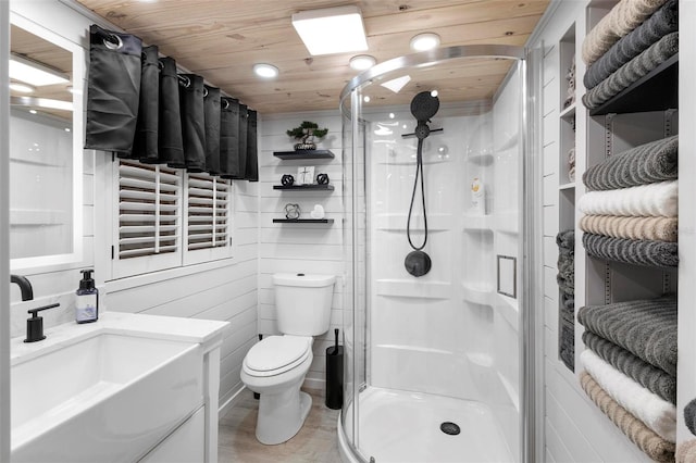 full bathroom featuring toilet, wooden ceiling, a stall shower, wood finished floors, and vanity