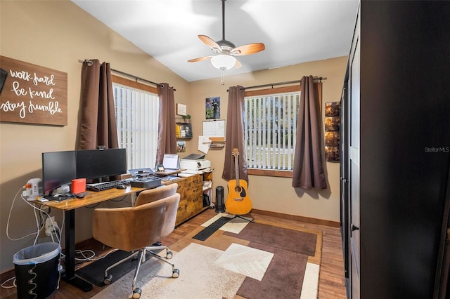 office space with wood finished floors, baseboards, lofted ceiling, and ceiling fan