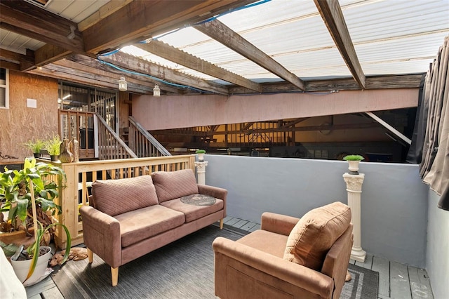 wooden terrace with an outdoor living space