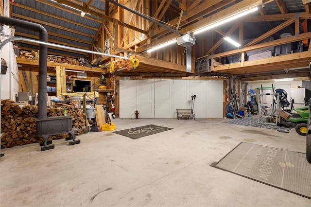 garage with a garage door opener and a wood stove