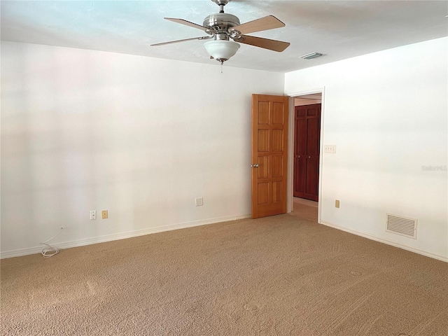 unfurnished room featuring light carpet, visible vents, and baseboards