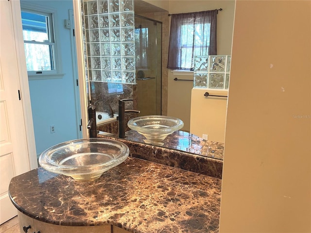 bathroom with a shower stall, a bath, and a sink