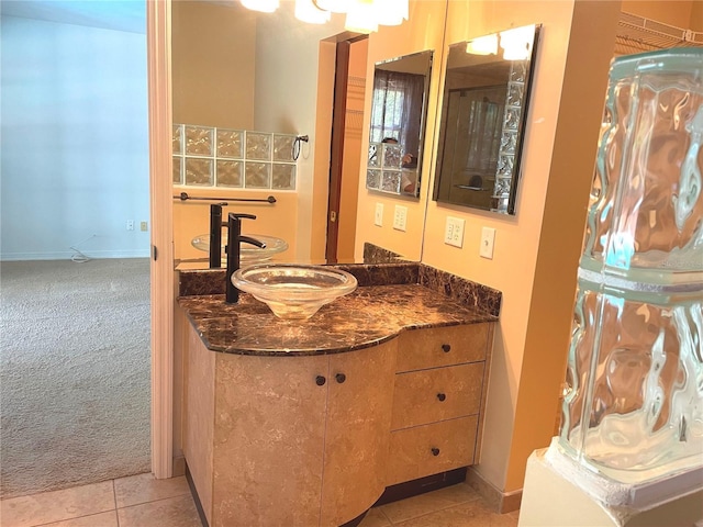 bathroom featuring tile patterned floors, baseboards, and vanity