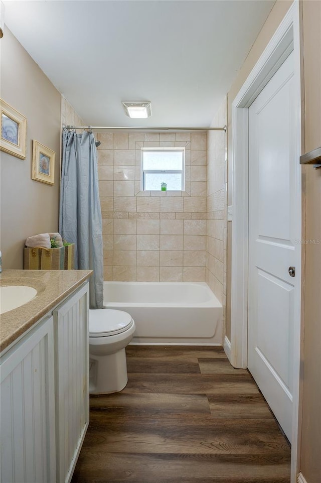 full bathroom featuring vanity, toilet, shower / bath combo, and wood finished floors