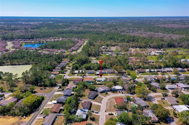 aerial view featuring a wooded view and a water view