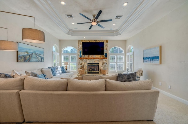 living room featuring a wealth of natural light, a fireplace, carpet, and a ceiling fan