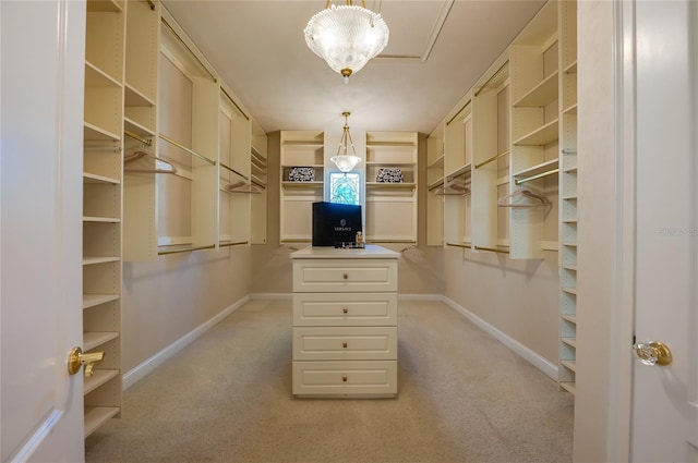 walk in closet with light colored carpet