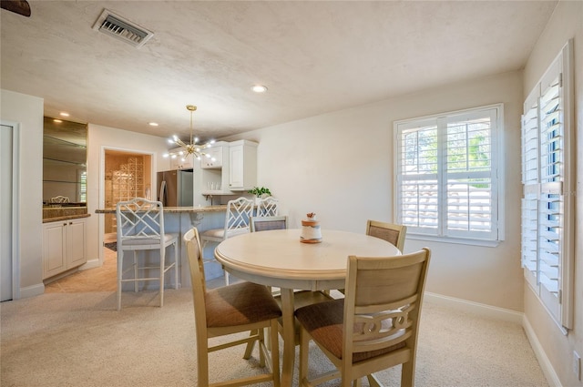 dining area with visible vents, light carpet, recessed lighting, baseboards, and a chandelier