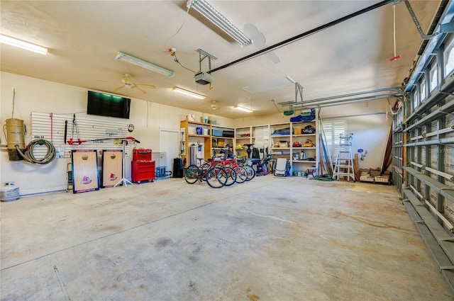 garage with a garage door opener and ceiling fan