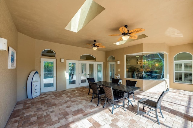 view of patio featuring a ceiling fan, outdoor dining area, and french doors