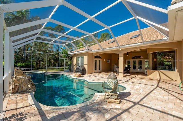 view of swimming pool with a lanai, french doors, a patio, and ceiling fan