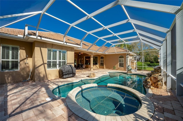 view of swimming pool with a patio area, a lanai, and a pool with connected hot tub