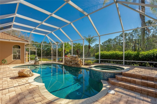 view of swimming pool featuring a lanai, a patio area, and a pool with connected hot tub