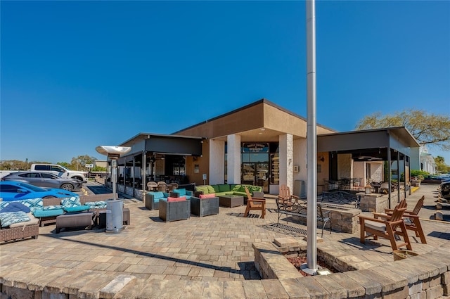 view of patio / terrace with an outdoor living space with a fire pit