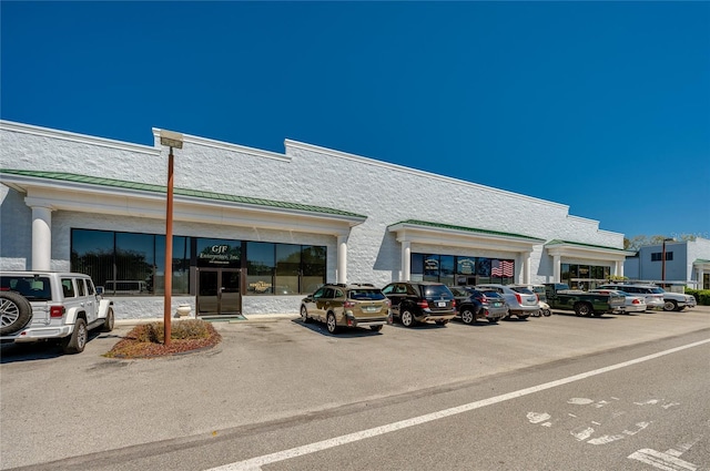 view of property featuring uncovered parking